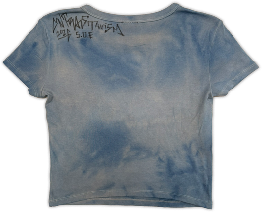 A blue and gray tie-dye cropped t-shirt shown from the back, featuring black handwritten text reading 'rise from the ashes' on the upper back.