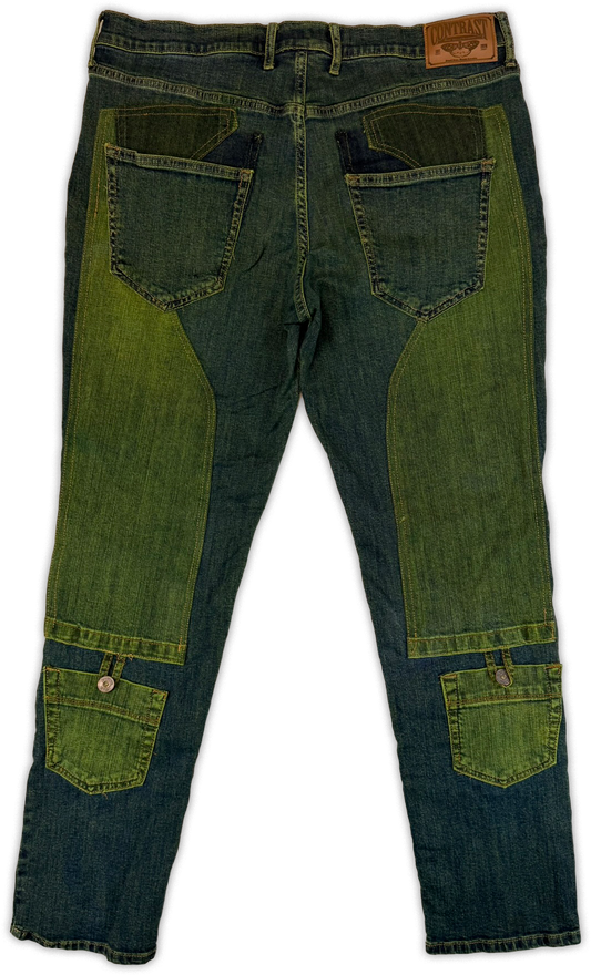 Back view of a pair of jeans with dark blue denim and large olive green patchwork panels on the thighs and lower legs, featuring cargo pockets and a brown leather patch on the back waistband.