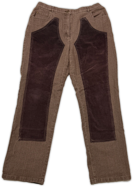 A pair of brown corduroy pants with large dark brown suede or velvet patch panels on the front of the thighs, shown flat against a white background.