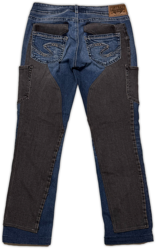 Rustic jeans with dark charcoal gray reinforced panels on the thighs and a brown leather contrast brand patch on the back waistband, shown from the back on a white background.