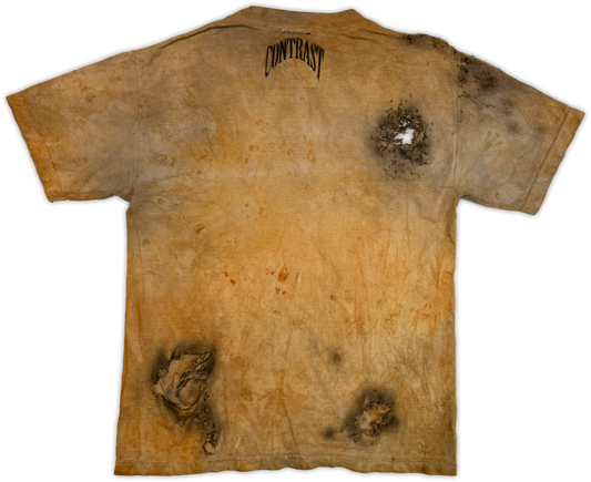 A short-sleeve t-shirt with a distressed, acid-washed tan and brown colorway, featuring dark burn-like graphic details and the word 'CONTRAST' printed in black arched text on the back neck.