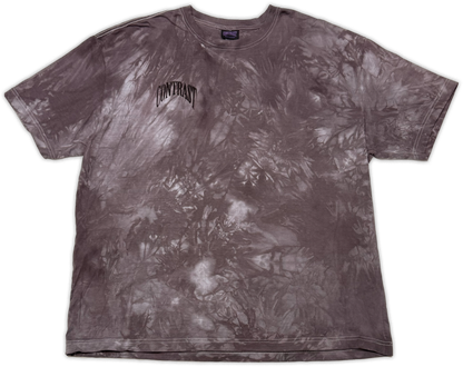 A short-sleeve crewneck t-shirt featuring a dark gray and white tie-dye pattern, with the word 'CONTRAST' printed in a stylized black font on the left chest.