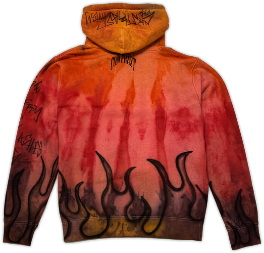 A hooded sweatshirt shown from the back, featuring a fiery orange, red, and yellow gradient wash with black flame graphics along the bottom hem and black graffiti-style text printed on the sleeves and hood.