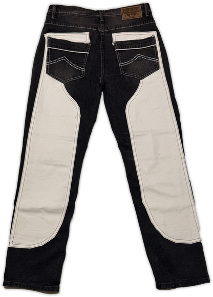 Black denim jeans with large off-white contrast panels on the inner thighs and pocket flaps, shown from the back on a white background.