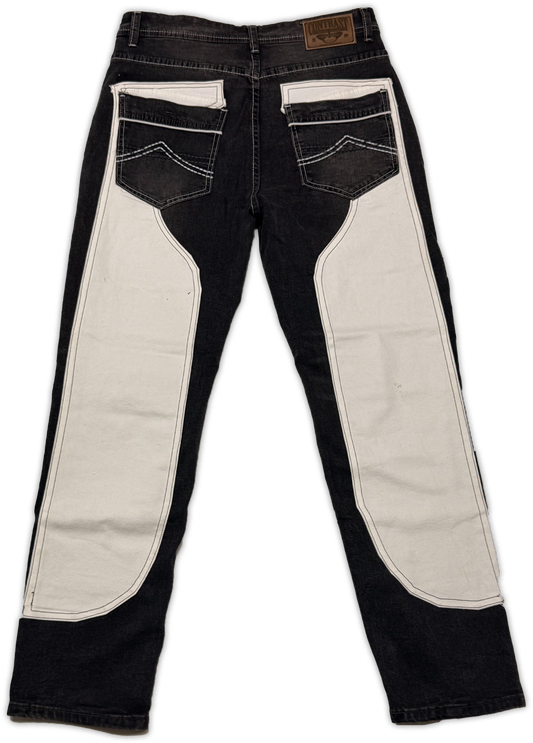 Black denim jeans with large off-white contrast panels on the inner thighs and pocket flaps, shown from the back on a white background.