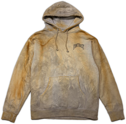 A tie-dye pullover hoodie in shades of tan, beige, and brown, featuring a black arched 'CONTRAST' logo on the left chest, displayed against a plain white background.