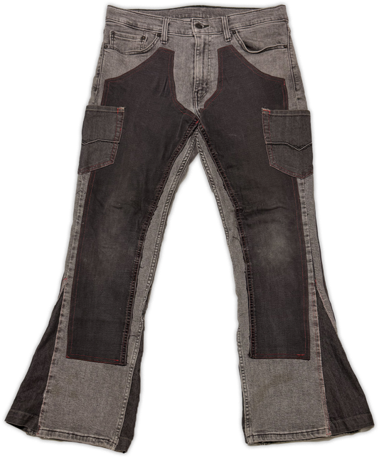 A pair of faded gray denim jeans with dark brown leather patchwork panels on the thighs and upper legs, displayed flat against a white background.