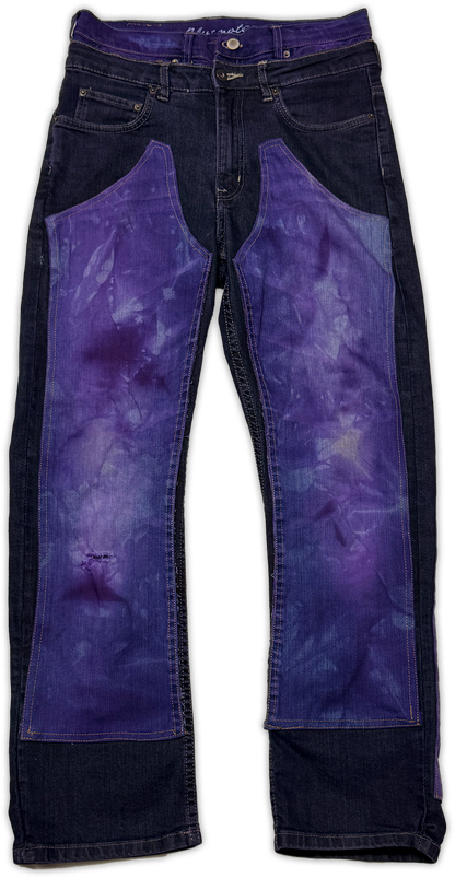 Dark blue denim jeans with large purple tie-dye patch panels on the front of both legs, shown flat against a white background.