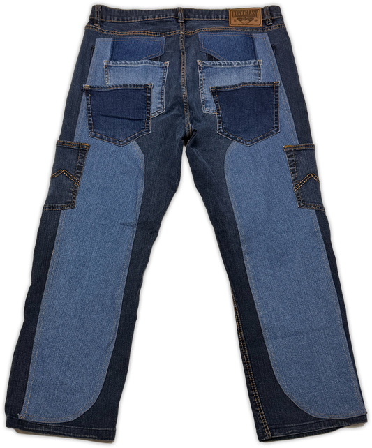 A pair of blue denim jeans shown from the back, featuring contrast panels of medium and dark blue denim, including large back pocket patches and side cargo pockets, on a white background.