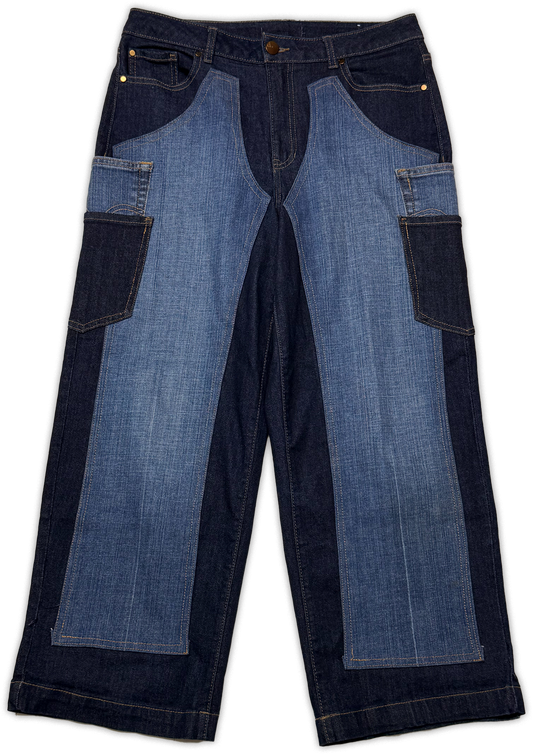 A pair of patchwork denim pants featuring light blue and dark navy blue denim panels, photographed flat against a white background.