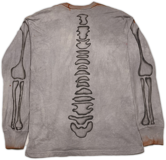 A gray long-sleeve t-shirt shown from the back, featuring a large black skeletal spine graphic down the center, with black skeletal arm and leg illustrations on both sides.