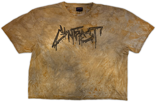 A short-sleeve crewneck t-shirt featuring a distressed, acid-washed tan and brown mottled pattern with a black graffiti-style 'Contrast' graphic printed across the chest.