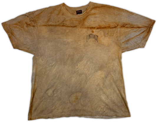 A faded, washed brown t-shirt with a distressed acid-wash look, featuring a small black 'CONTRAST' logo on the left chest, displayed flat against a white background.