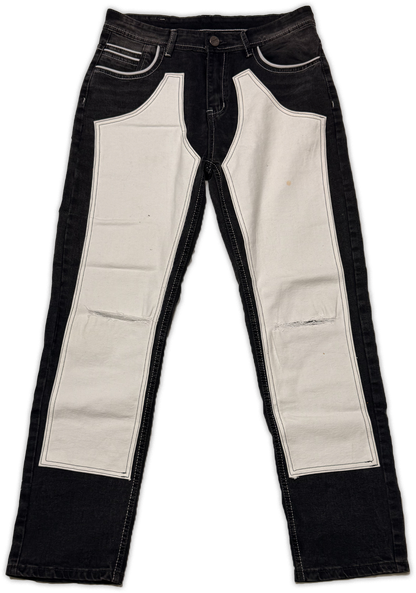 Black denim jeans with large off-white canvas panels on the front of the legs, photographed flat against a white background.