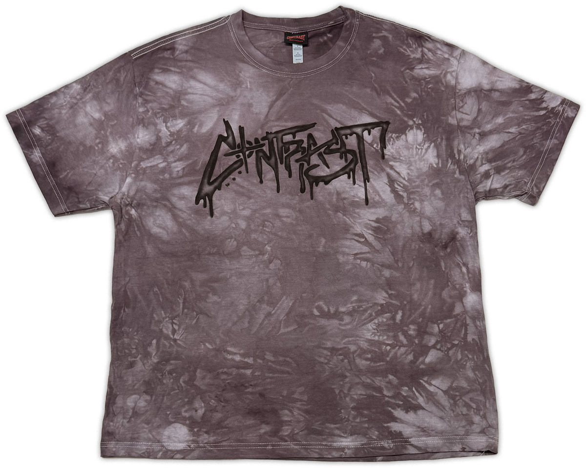 A short-sleeve crewneck t-shirt featuring a mottled, mineral-washed tie-dye pattern in dark gray and brownish tones, with a black 'contrast' band logo printed across the chest.
