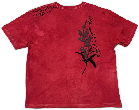 A red acid-wash t-shirt with a black floral graphic on the back featuring the text 'rise fro the ashes' and 'contrast' printed on the shoulder.