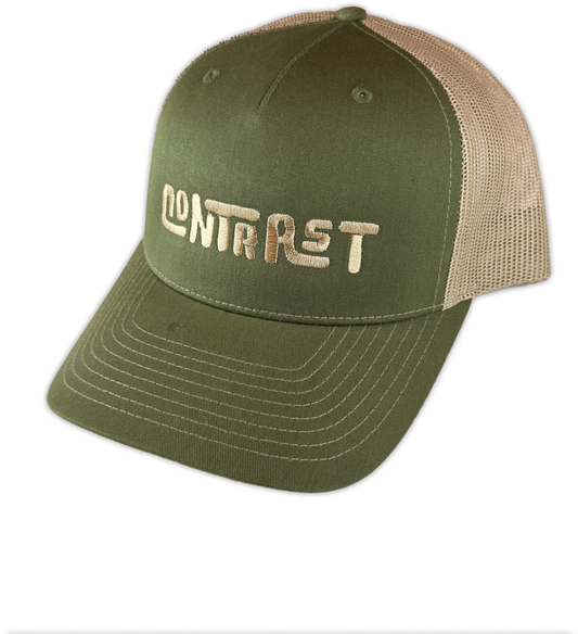 An olive green and tan trucker hat with 'CONTRAST' embroidered in tan on the front panel, shown on a plain white background.