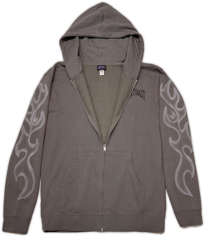 A dark gray zip-up hoodie with a gray interior lining, featuring a black 'contrast' logo on the right chest and gray flame-like graphics on both sleeves, shown against a plain white background.